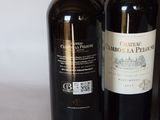 three bottles of wine sitting on top of a table next to each other