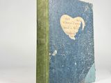 a blue book with a green cover and a heart on it