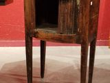 a small wooden table with a small cabinet on it