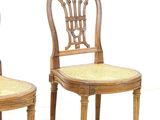 pair of wooden chairs with wicker seats on white background