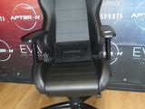 a black office chair that is on a wooden floor