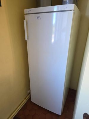 a white refrigerator in the corner of a room