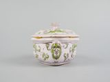 an image of a white and green bowl with a lid