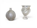 two vases sitting next to each other on a white surface