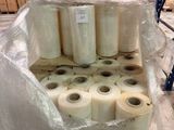 several rolls of plastic are stacked on top of a pallet in a warehouse