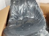 a cardboard box with a black chair in it