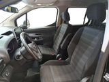 the interior of a small car with black seats and a steering wheel