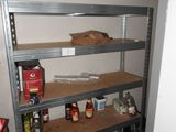 a shelf with bottles and cans on it in the corner of a room