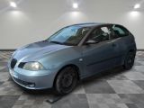 a blue car that is parked in a room