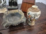 two vases and a bowl on a wooden table