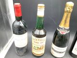 several bottles of wine are lined up on a counter