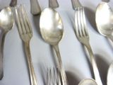 a lot of silver spoons and forks on the table