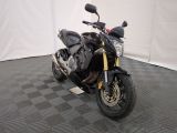 a picture of a black motorcycle parked on a checkered floor