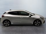 the silver car is parked on the concrete floor in the room