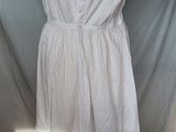 the dress is white and has a lace overlay on it