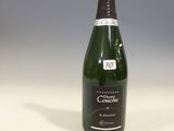 an empty bottle of champagne sitting on top of a white table