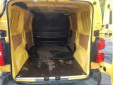 a yellow van with the door open and a black mat in the back
