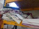 a pile of folded towels on a shelf in a room