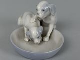 porcelain figurine of two dogs and a cat on a plate