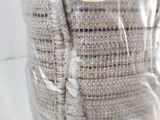 a bag of fabric wrapped around a vase on a table