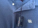 a close up of a polo shirt with a tag on it