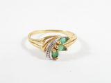 a gold ring with emerald stones and diamonds