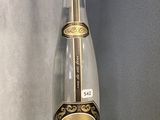 a bottle that is sitting on a glass shelf