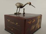 a bird that is standing on top of a box