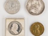 three different coins and a coin with a picture of a man on one of them