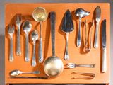 a wooden tray with silverware and spoons on it