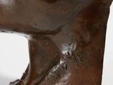 a close up of a sculpture of a man ' s head on a white surface