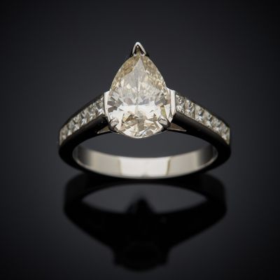 an engagement ring with a pear shaped diamond set in white gold