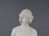 a statue of a woman with a flower in her hair