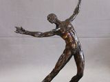 statue of a man holding a tennis racquet on a marble base