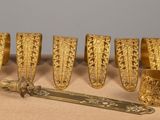 several pieces of gold are arranged in a row on a table