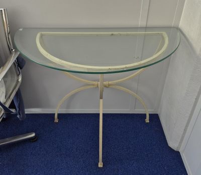 a glass table with a glass top on a blue carpet