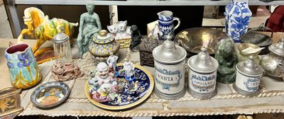 many different vases on a table with a plate on it