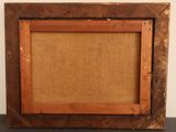 an old picture frame with a picture of a person in it
