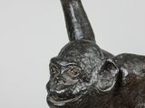 statue of a monkey with a stick in its hand