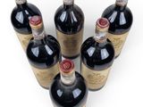 several bottles of wine are lined up in a row