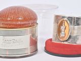 two tins that are sitting next to each other on a table