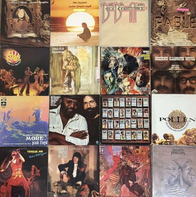 many different album covers on the wall of this room