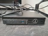 a small black computer on a table with wires on it