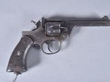 a gun that is sitting on a white surface