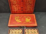 an old chinese game set with two trays and a game board