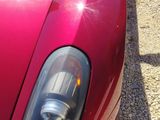 a red sports car parked on the side of the road