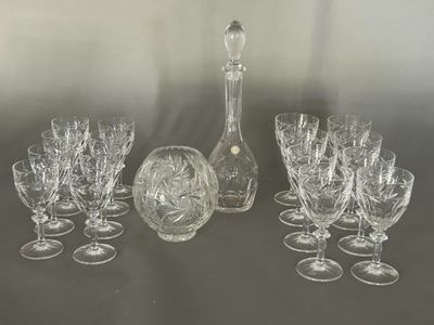 a lot of wine glasses and a decanter on the table