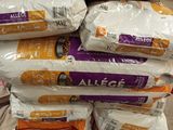 several bags of rice stacked on top of each other in a store