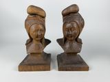 pair of wooden busturines of a woman and a man