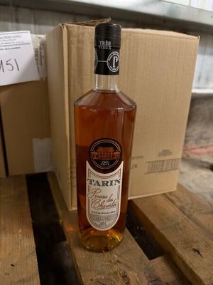 a bottle of wine sitting on a table next to a box